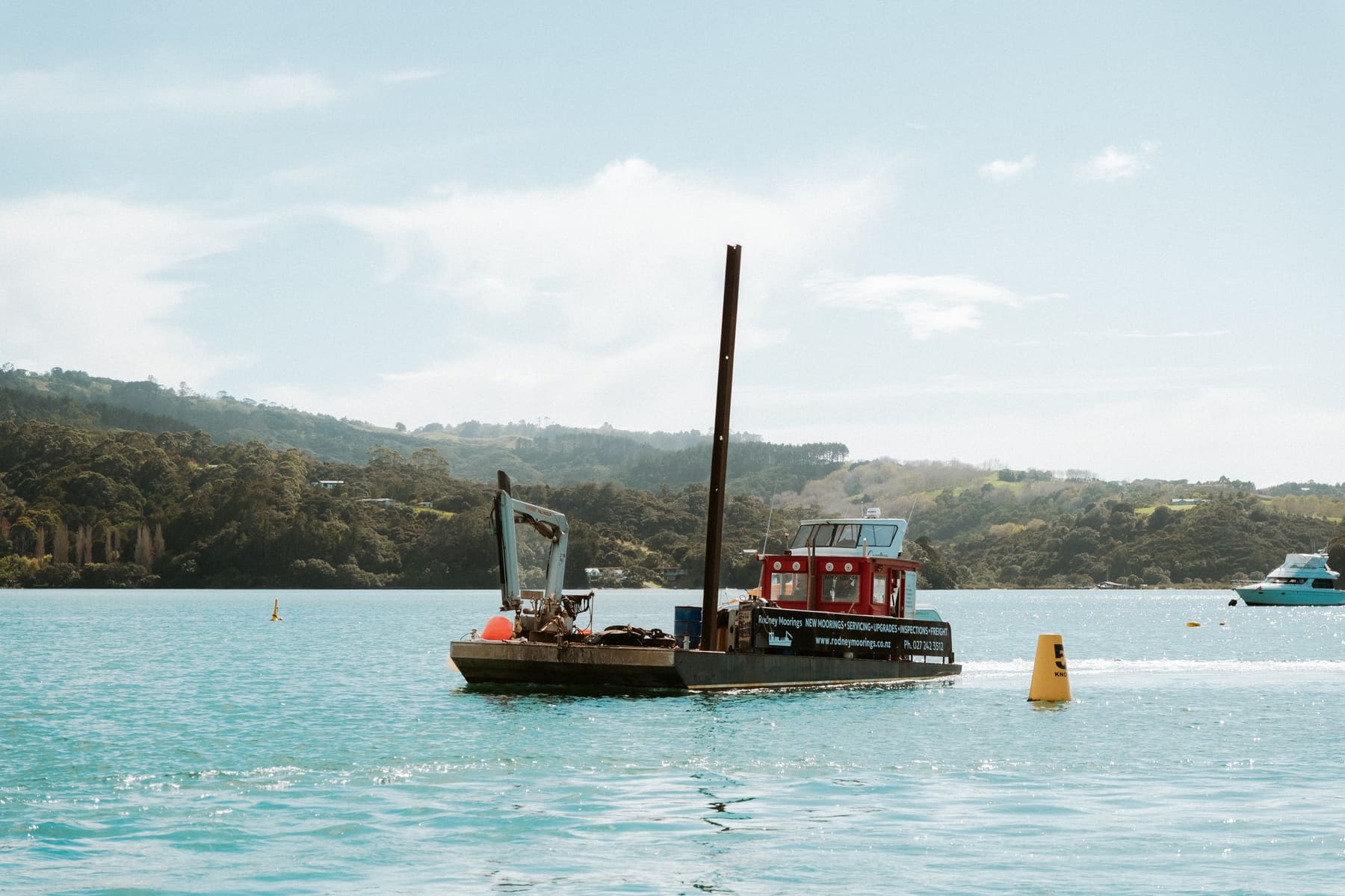 Rodney Mooring Services workboat with HIAB crane underway